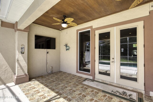 3 Indian Springs Dr, Ormond Beach, FL 32174 - doorway to property featuring french doors, a ceiling fan, and stucco siding