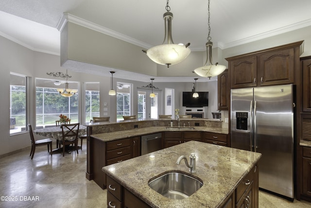 3 Indian Springs Dr, Ormond Beach, FL 32174 - kitchen featuring appliances with stainless steel finishes, crown molding, light stone countertops, decorative light fixtures, and a peninsula
