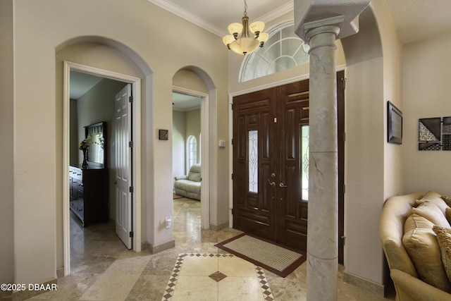 3 Indian Springs Dr, Ormond Beach, FL 32174 - entryway with crown molding, arched walkways, a chandelier, and inlaid floor details