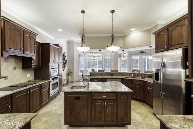 3 Indian Springs Dr, Ormond Beach, FL 32174 - kitchen featuring appliances with stainless steel finishes, crown molding, a peninsula, pendant lighting, and decorative backsplash