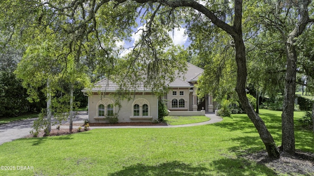 3 Indian Springs Dr, Ormond Beach, FL 32174 - view of front of home featuring stucco siding, a front lawn, and driveway