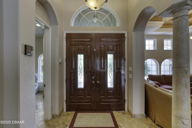 3 Indian Springs Dr, Ormond Beach, FL 32174 - entryway with arched walkways, a towering ceiling, and crown molding
