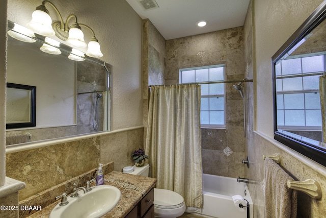 3 Indian Springs Dr, Ormond Beach, FL 32174 - full bathroom with shower / bath combination with curtain, vanity, a textured wall, and wainscoting