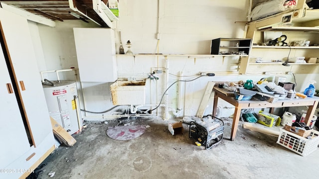 misc room with water heater, a sink, and concrete flooring