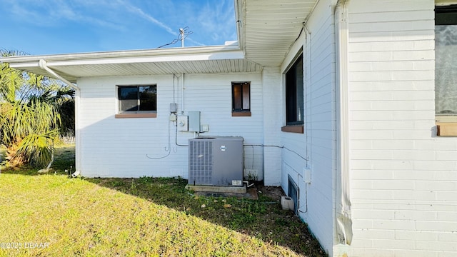 view of home's exterior featuring a lawn and cooling unit