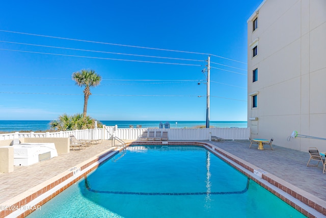 view of swimming pool with a water view