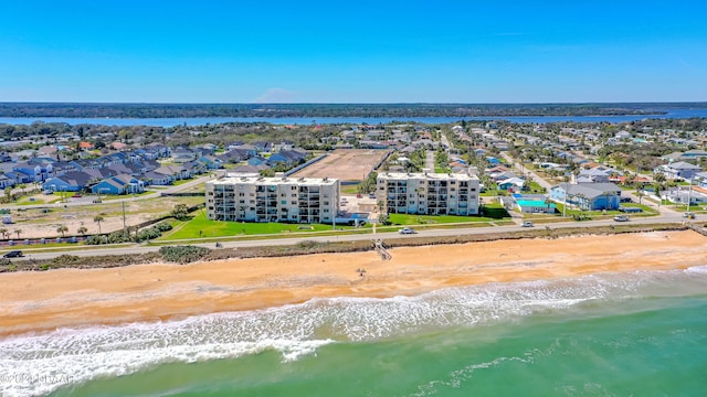 drone / aerial view featuring a view of the beach and a water view