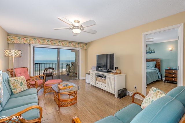 living room with ceiling fan and light hardwood / wood-style flooring