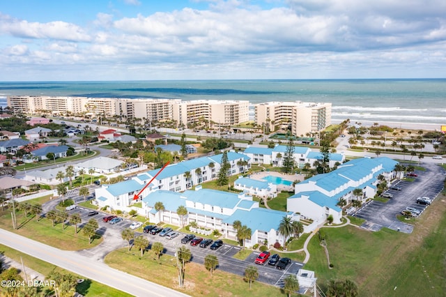 birds eye view of property with a water view and a view of the beach