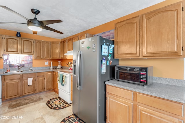 kitchen with white range, sink, ceiling fan, stainless steel fridge, and light tile patterned floors