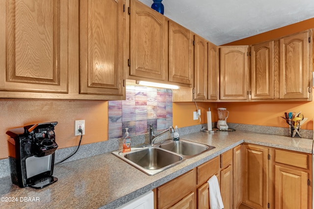 kitchen featuring decorative backsplash and sink