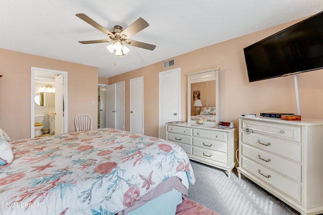 bedroom featuring ensuite bath, ceiling fan, and carpet