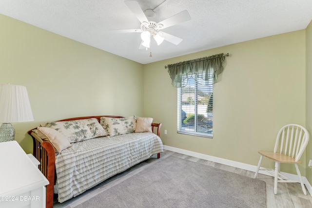 interior space featuring a textured ceiling, light hardwood / wood-style floors, and ceiling fan