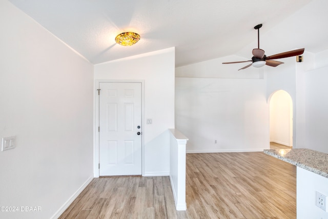 foyer featuring light wood-type flooring, lofted ceiling, and ceiling fan