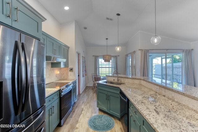 kitchen featuring lofted ceiling, decorative light fixtures, and appliances with stainless steel finishes