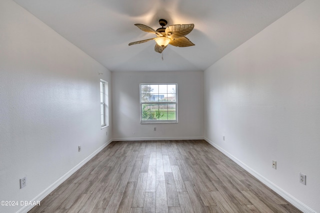 empty room with light hardwood / wood-style floors and ceiling fan