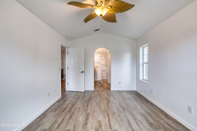 unfurnished bedroom with ensuite bathroom, ceiling fan, light hardwood / wood-style flooring, and lofted ceiling