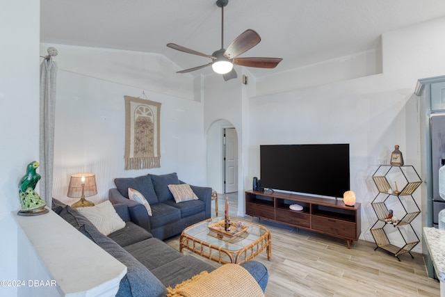 living room with light hardwood / wood-style flooring, lofted ceiling, and ceiling fan