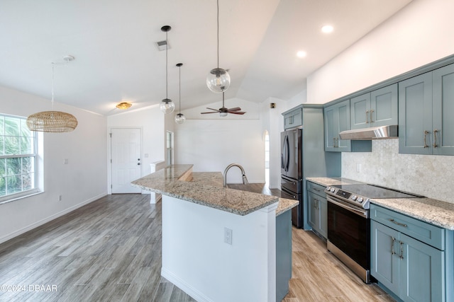 kitchen with pendant lighting, stainless steel appliances, lofted ceiling, and a kitchen island with sink