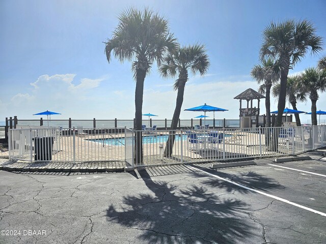 1233 S Atlantic Ave Unit 1040, Daytona Beach, FL 32118 - view of patio with a water view and a grill
