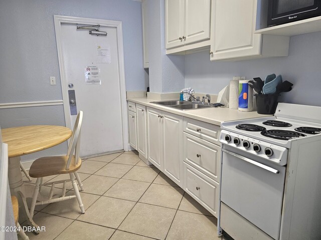 1233 S Atlantic Ave Unit 1040, Daytona Beach, FL 32118 - kitchen featuring a sink, light countertops, white cabinetry, electric range, and light tile patterned flooring