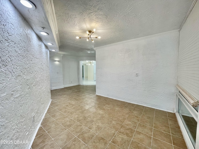 empty room featuring tile patterned flooring, ornamental molding, a chandelier, and a textured ceiling