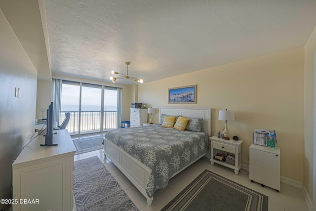 bedroom with light tile patterned flooring, a notable chandelier, a textured ceiling, and access to outside