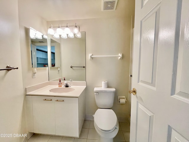 bathroom featuring vanity, tile patterned flooring, and toilet