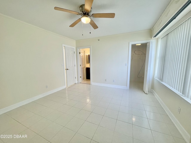 unfurnished bedroom featuring light tile patterned flooring, ceiling fan, a spacious closet, and a closet