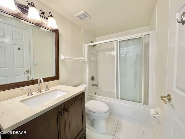 full bathroom with tile patterned flooring, vanity, combined bath / shower with glass door, and toilet