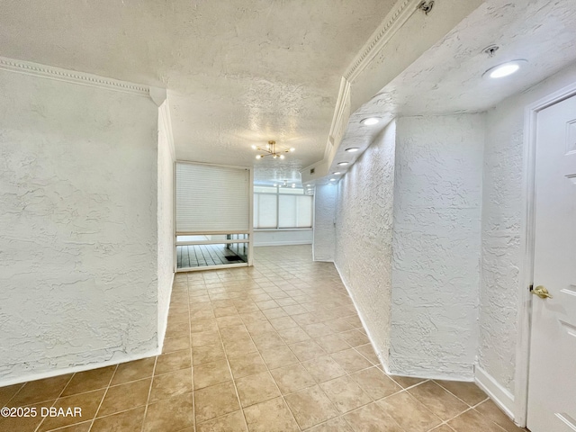 hallway featuring tile patterned flooring and a textured ceiling