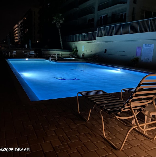 view of pool at night