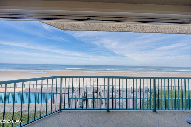 balcony with a view of the beach and a water view