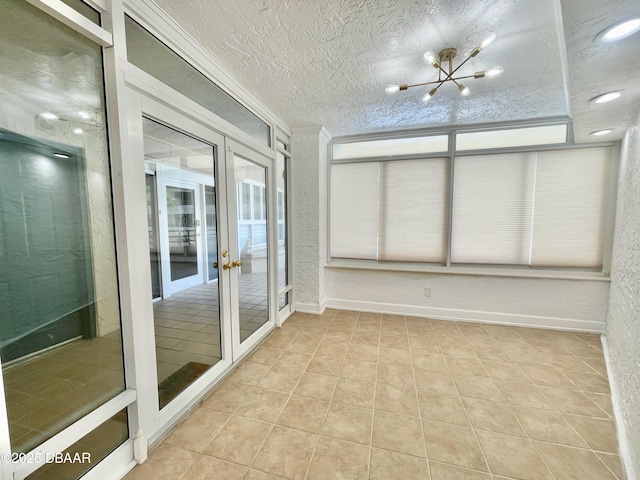 unfurnished sunroom with french doors and a chandelier