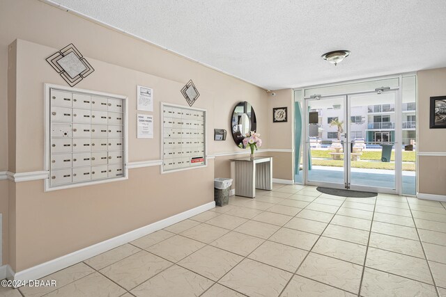 interior space featuring a mail area and a textured ceiling