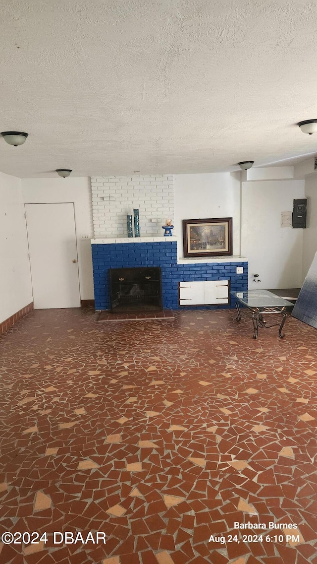 unfurnished living room with a textured ceiling