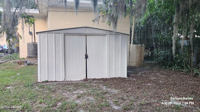 view of outbuilding featuring central AC unit