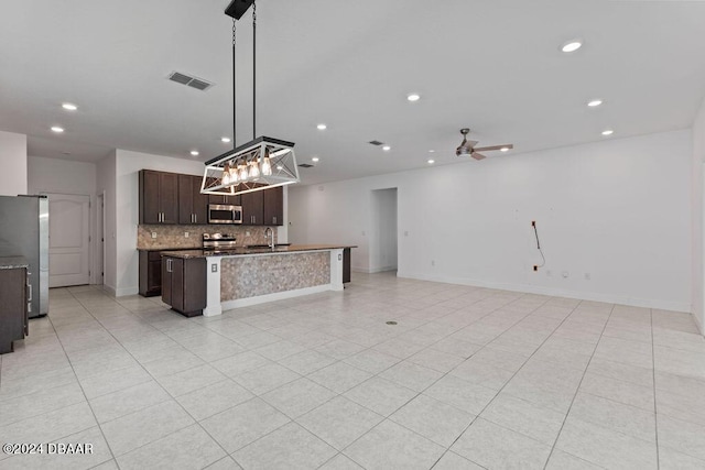 kitchen with sink, hanging light fixtures, ceiling fan, appliances with stainless steel finishes, and dark brown cabinetry