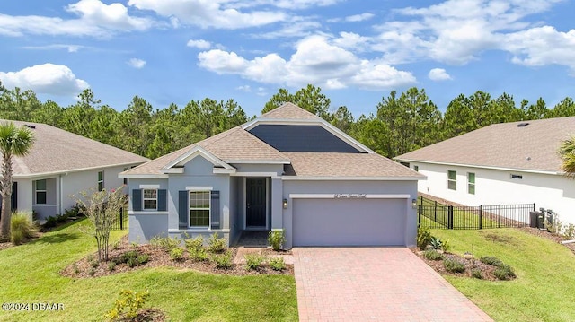 view of front of property with central AC, a garage, and a front lawn