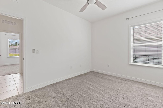 unfurnished room featuring light carpet and ceiling fan