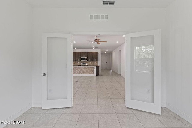 hallway featuring light tile patterned floors