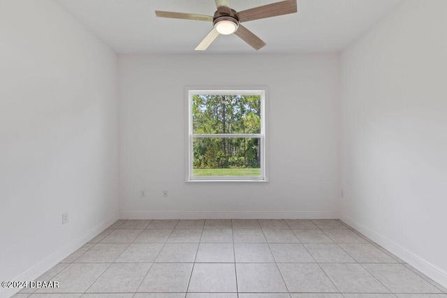 unfurnished room with ceiling fan and light tile patterned floors