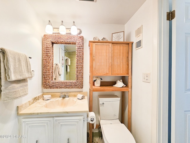 bathroom with toilet and vanity