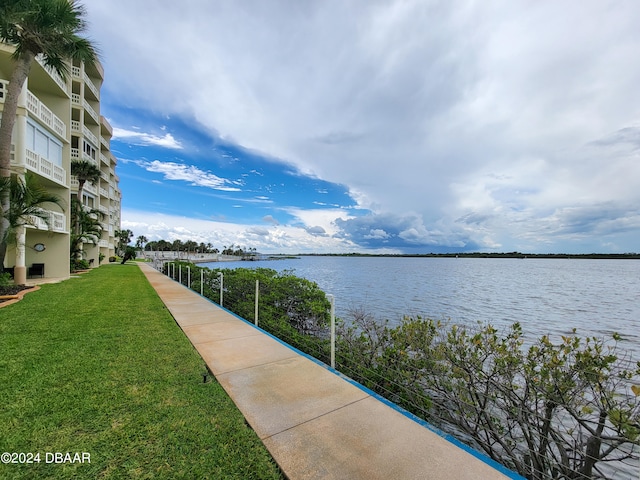 view of home's community featuring a water view and a lawn