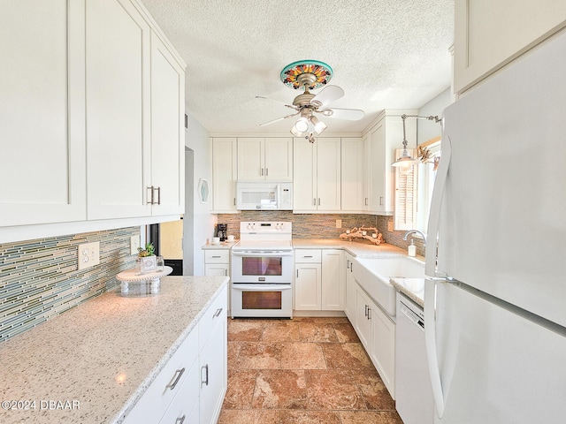 kitchen with white cabinets, a textured ceiling, sink, ceiling fan, and white appliances