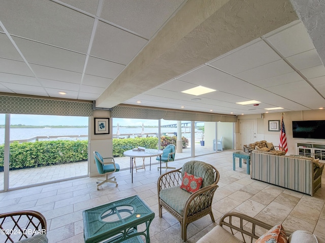 3606 S Peninsula Dr Unit 614, Port Orange, FL 32127 - living room featuring a water view, plenty of natural light, and a paneled ceiling