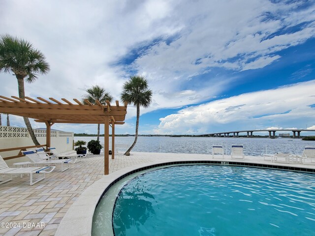 3606 S Peninsula Dr Unit 614, Port Orange, FL 32127 - community pool with a water view, a pergola, and a patio