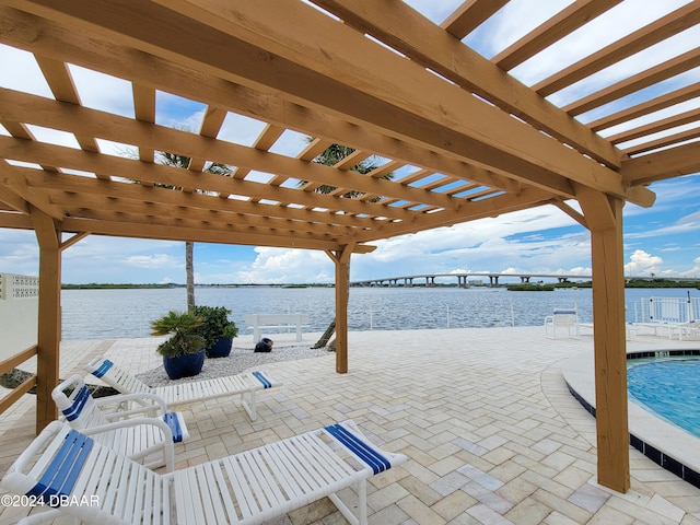 view of patio / terrace with a water view and a pergola