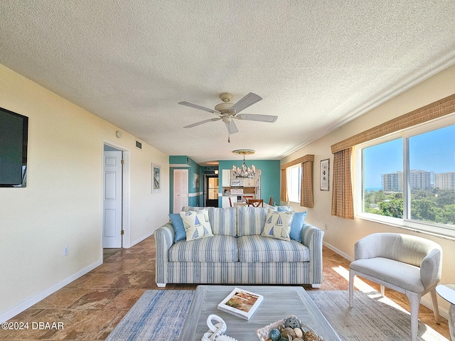 living room with ceiling fan and a textured ceiling