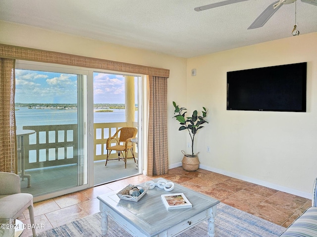 3606 S Peninsula Dr Unit 614, Port Orange, FL 32127 - living area featuring ceiling fan, baseboards, and a textured ceiling